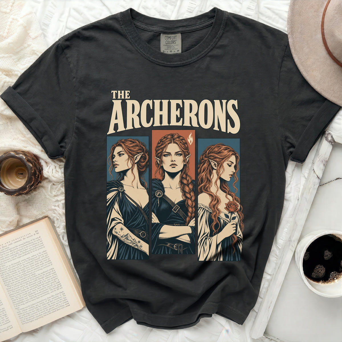 The Archerons t-shirt features three women with pointed ears and ornate clothing.