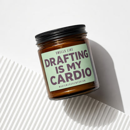 Candle with "Smells Like Drafting Is My Cardio" text in purple on a mint green label.