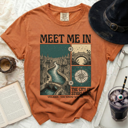 Orange t-shirt with "Meet Me In Velaris You Know Where" graphic featuring a city and compass.