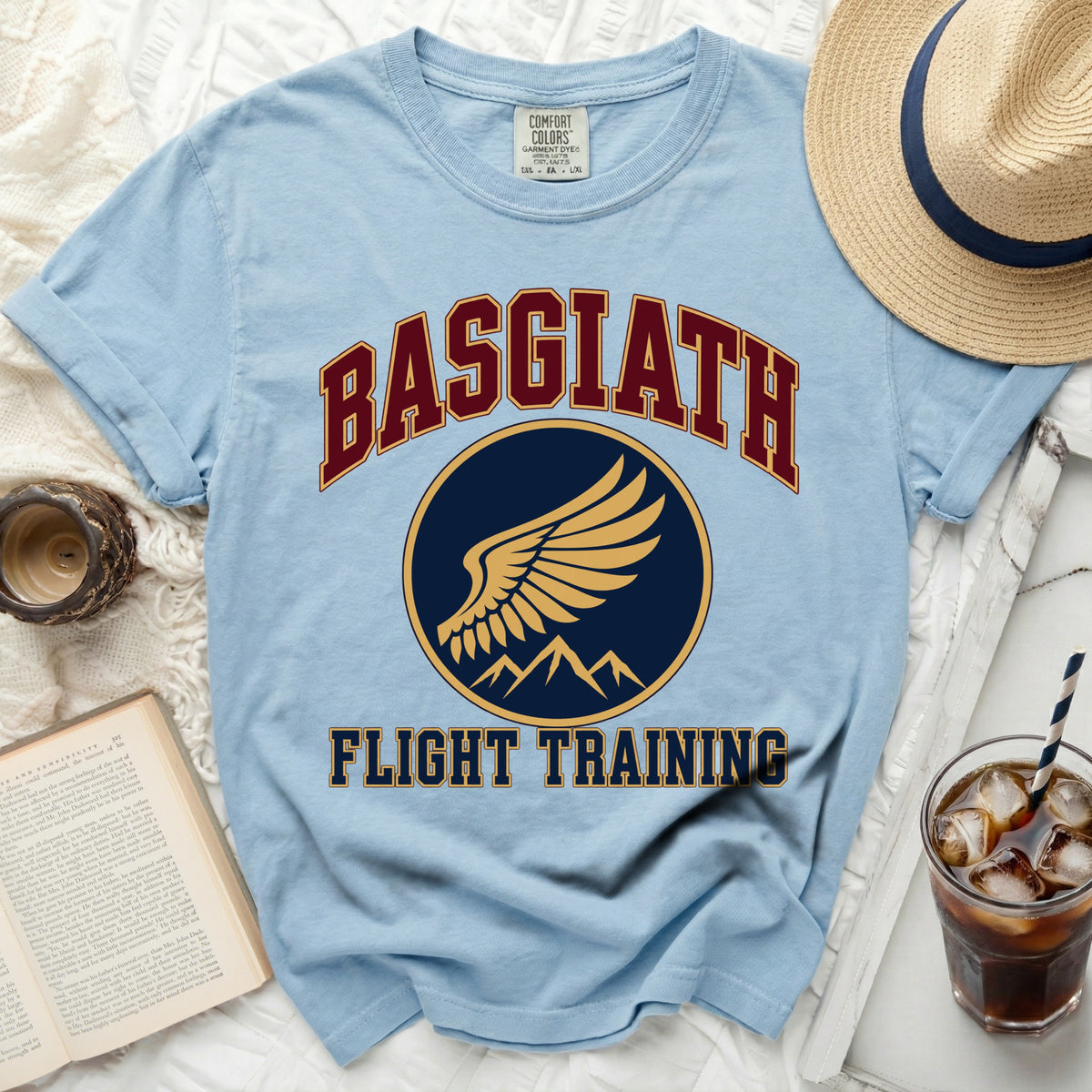 Light blue t-shirt with "BASGIATH FLIGHT TRAINING" text and a winged emblem.
