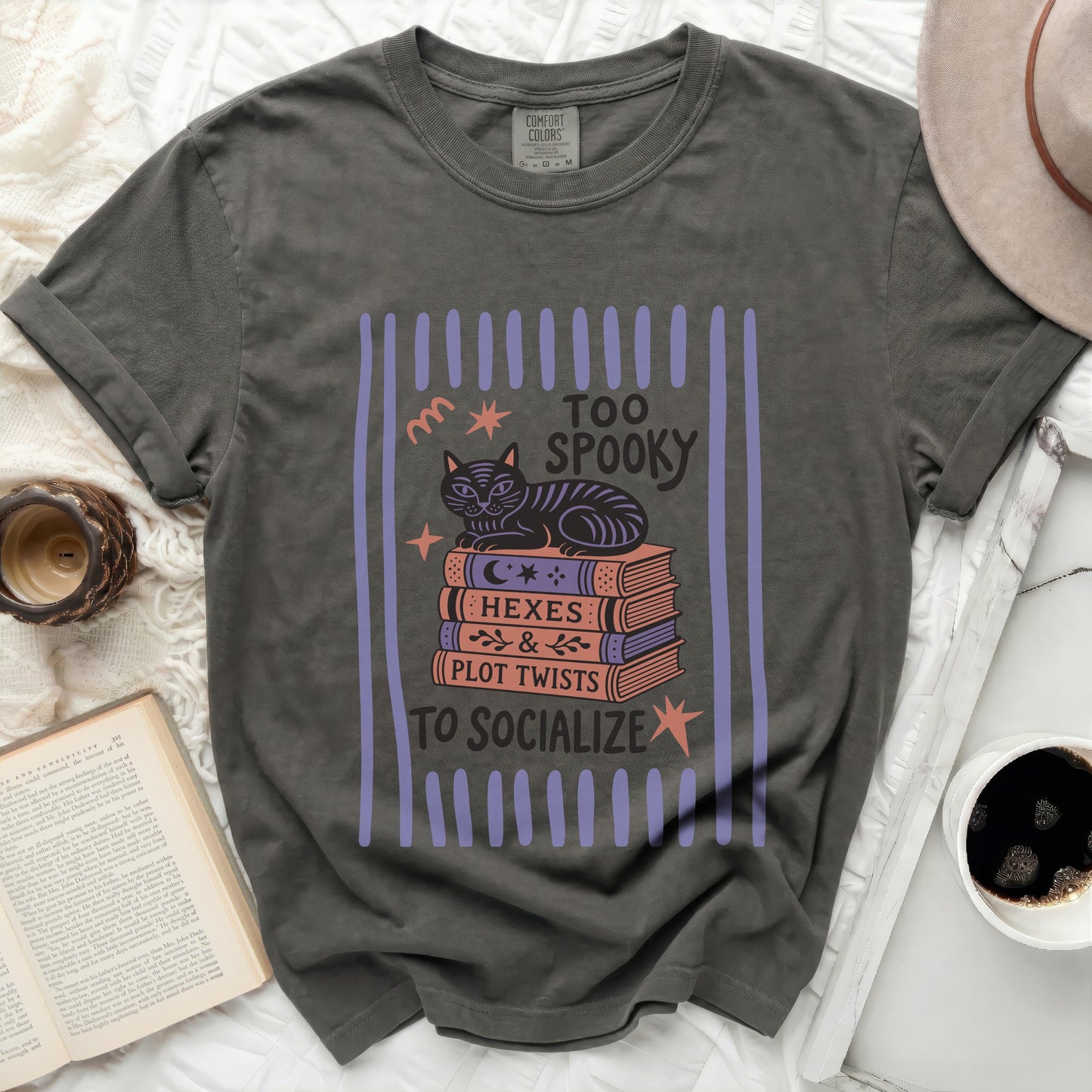 T-shirt with cat on books, "Too Spooky to Socialize" text.