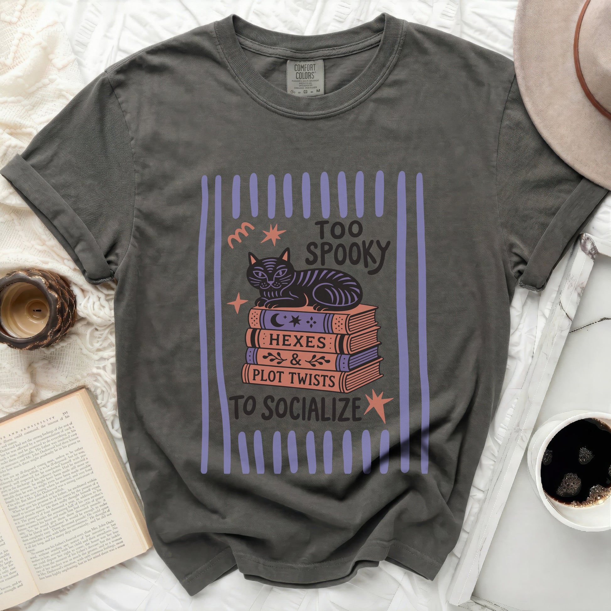 T-shirt with cat on books, "Too Spooky to Socialize" text.