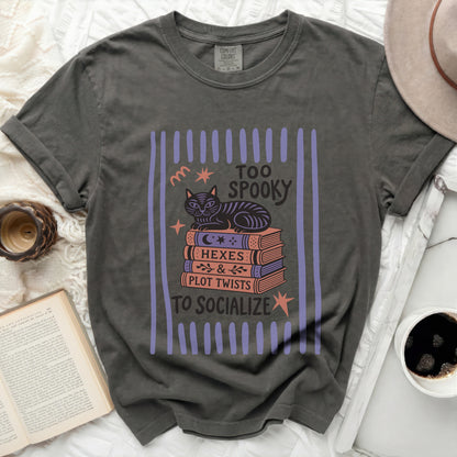 T-shirt with cat on books, "Too Spooky to Socialize" text.