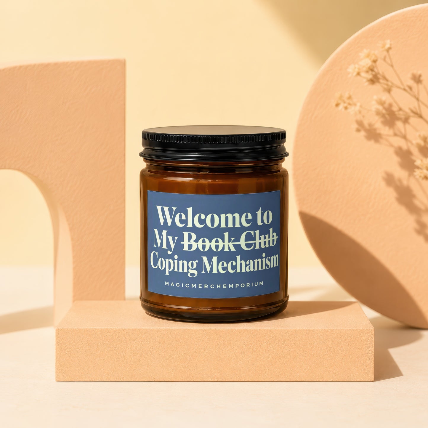 Amber jar candle with blue label reading "Welcome to My Book Club Coping Mechanism".
