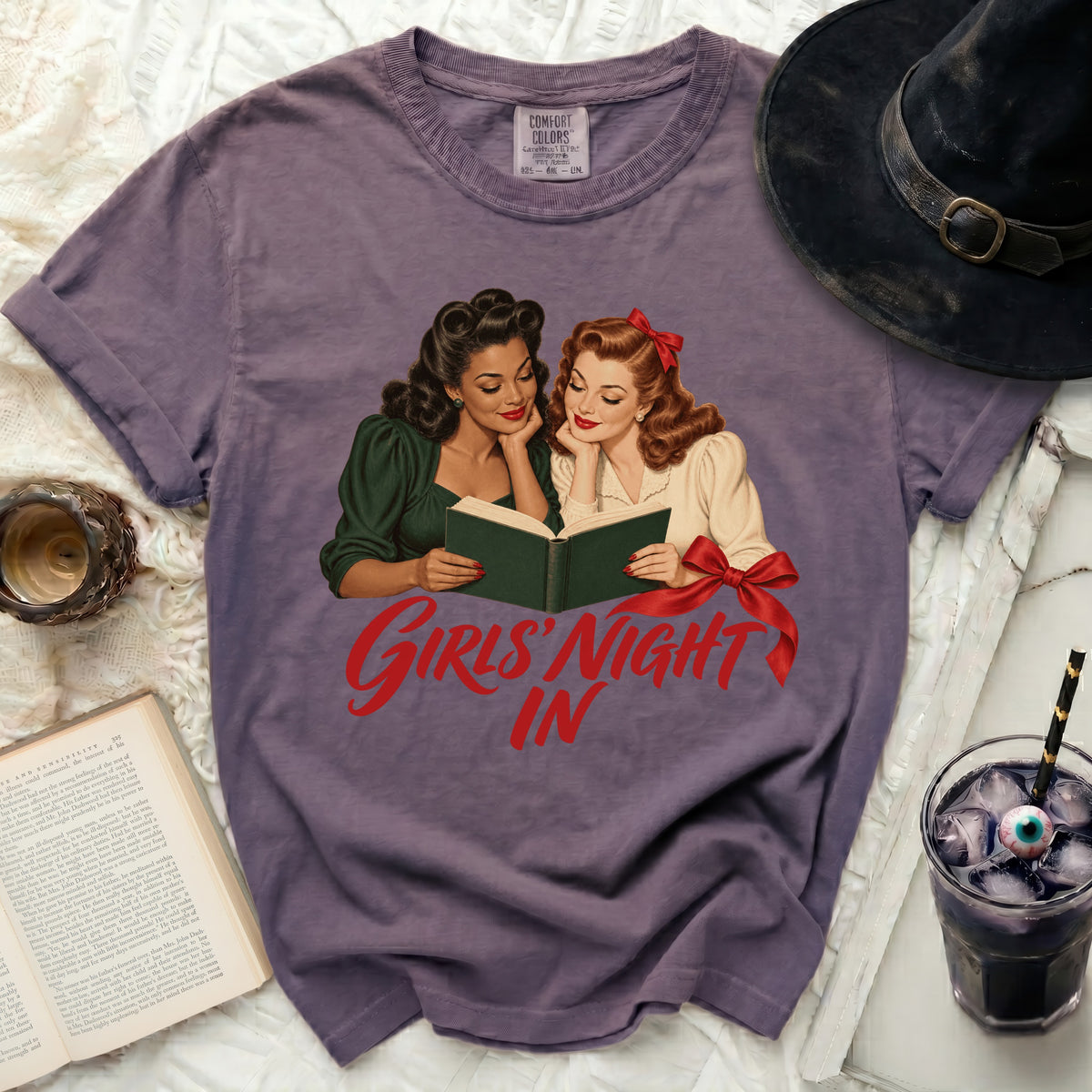 T-shirt with retro illustration of two women reading and text "Girls' Night In".