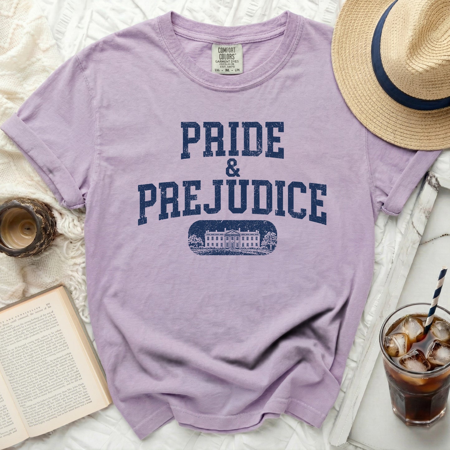Lavender t-shirt with "Pride & Prejudice" and a building graphic.