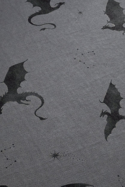 a pattern of black silhouettes of dragons against a gray background.