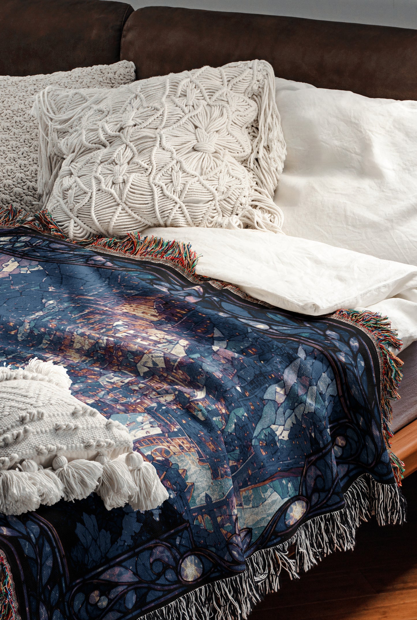a cozy and inviting bedroom scene, featuring a bed with a blue and white patterned blanket, a white pillow, and a brown leather couch.