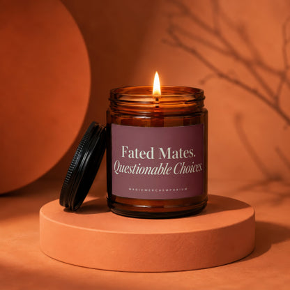 Amber glass candle with lit flame and lid off, reads "Fated Mates. Questionable Choices."