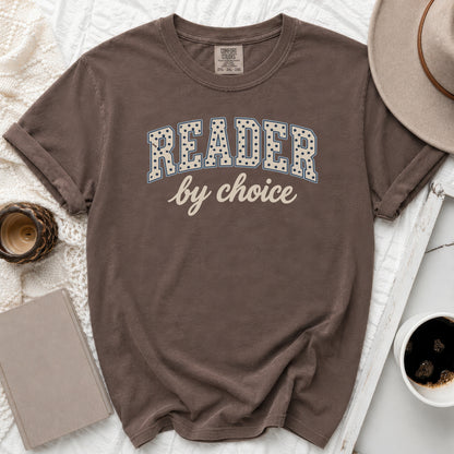 Brown t-shirt with "READER by choice" text, featuring a hat and coffee.