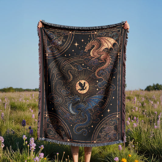 A person is holding up a large, intricately designed blanket with a dragon and star motif, standing in a field of purple flowers.