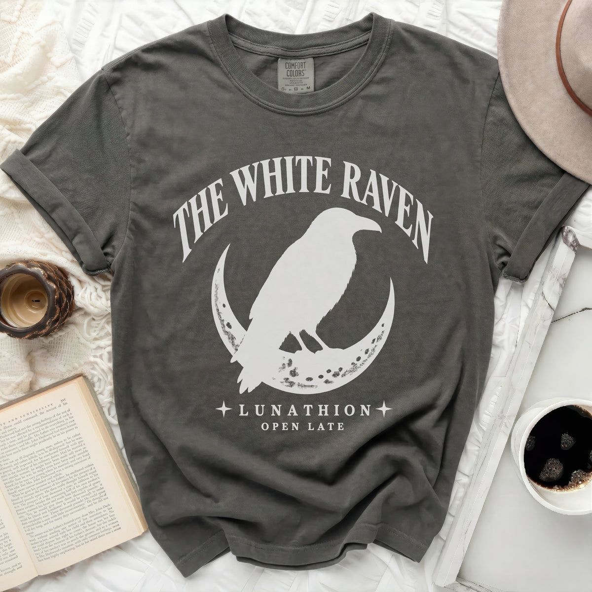 Dark grey t-shirt with white raven on crescent moon and text "THE WHITE RAVEN".