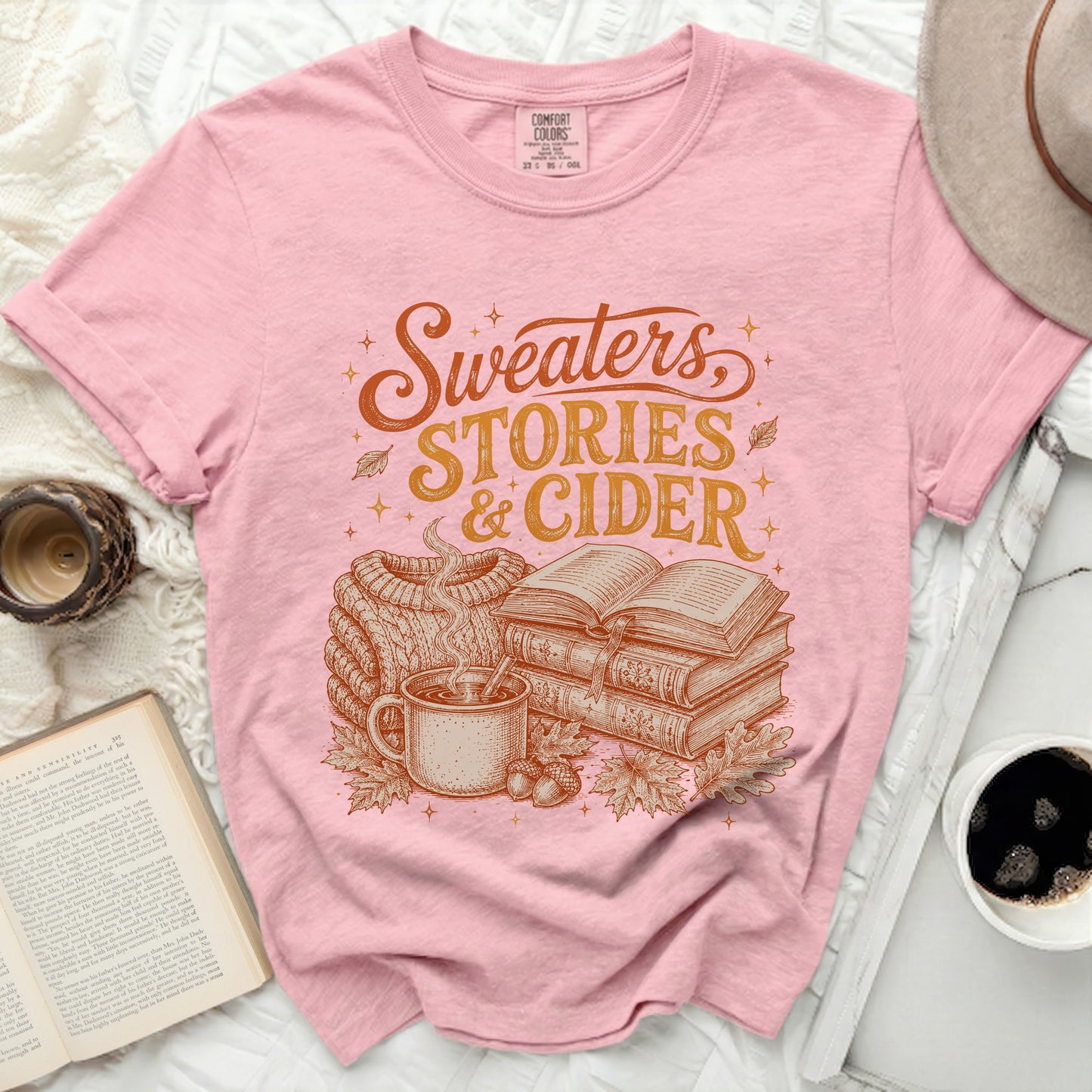 Pink t-shirt with "Sweaters, Stories & Cider" graphic and autumn theme.