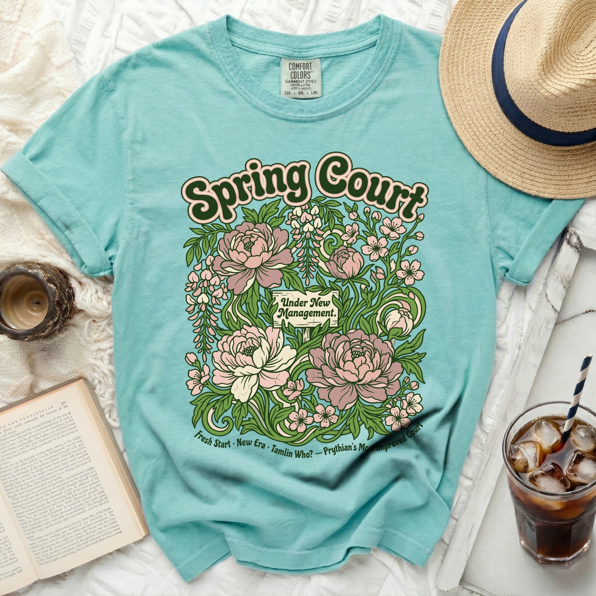 Aqua t-shirt with "Spring Court Under New Management" floral graphic.