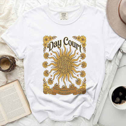 White Comfort Colors t-shirt with "Day Court" sun graphic and floral accents.