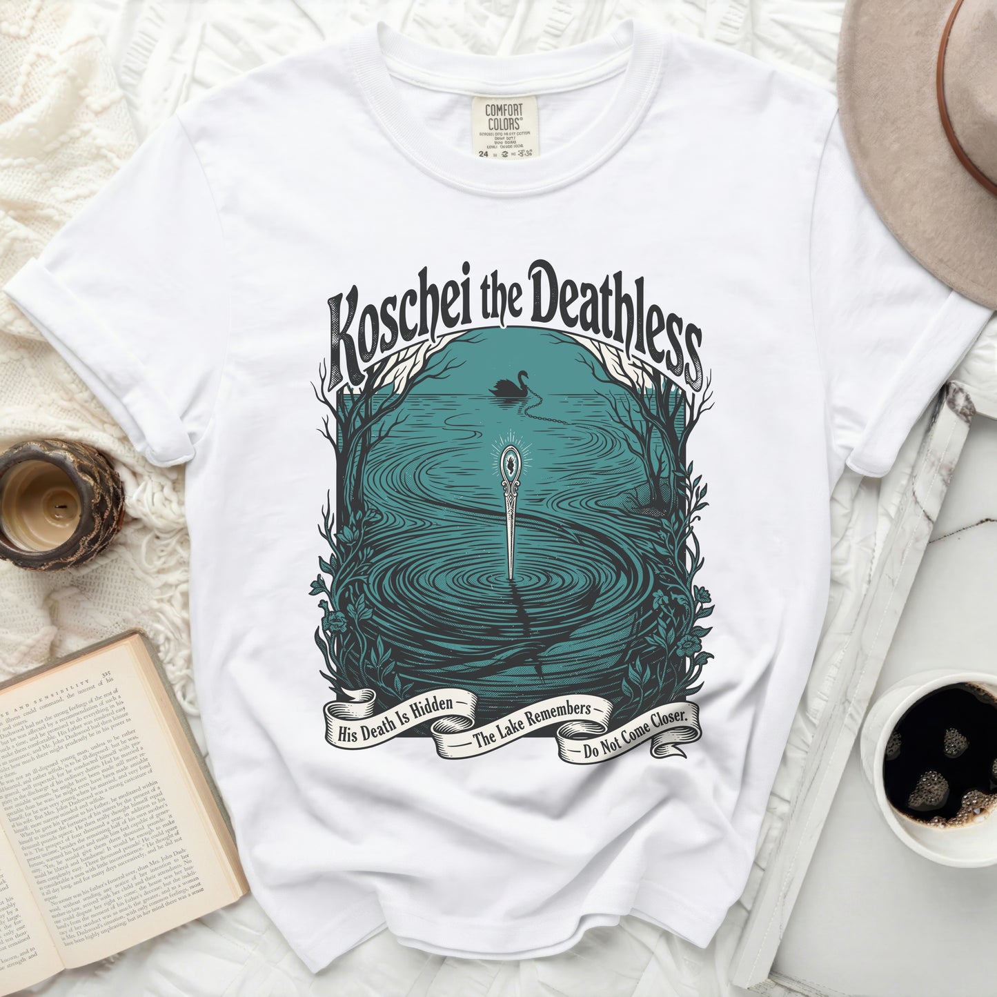 White t-shirt with "Koschei the Deathless" graphic and banner text.