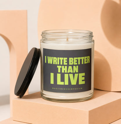 Glass candle with black lid, reads "I WRITE BETTER THAN I LIVE".