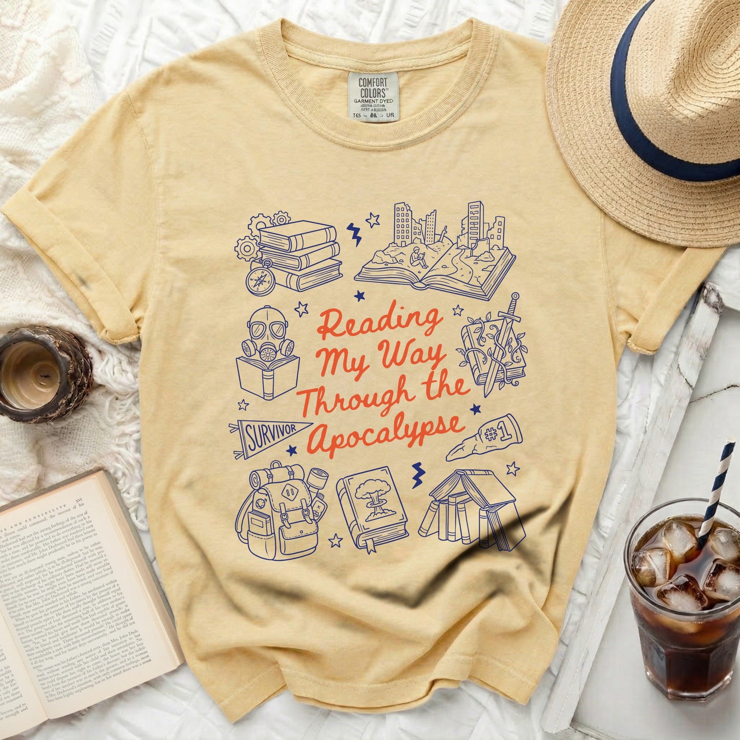 Yellow graphic tee with "Reading My Way Through the Apocalypse" text and illustrations.