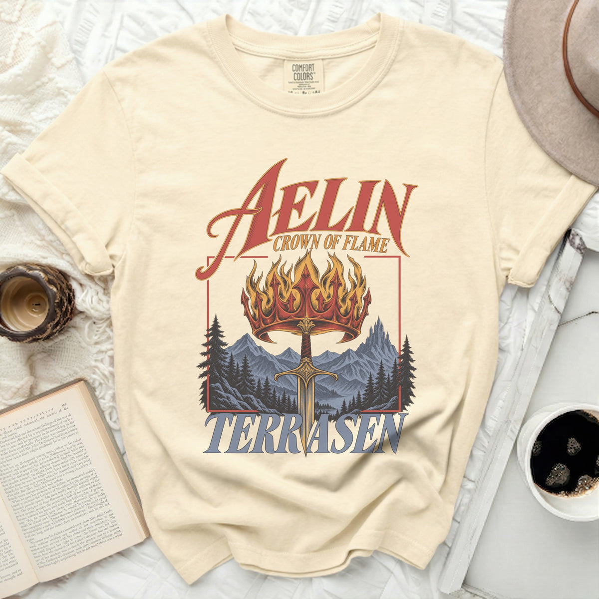 Cream t-shirt with "Aelin Crown of Flame Terrasen" graphic.
