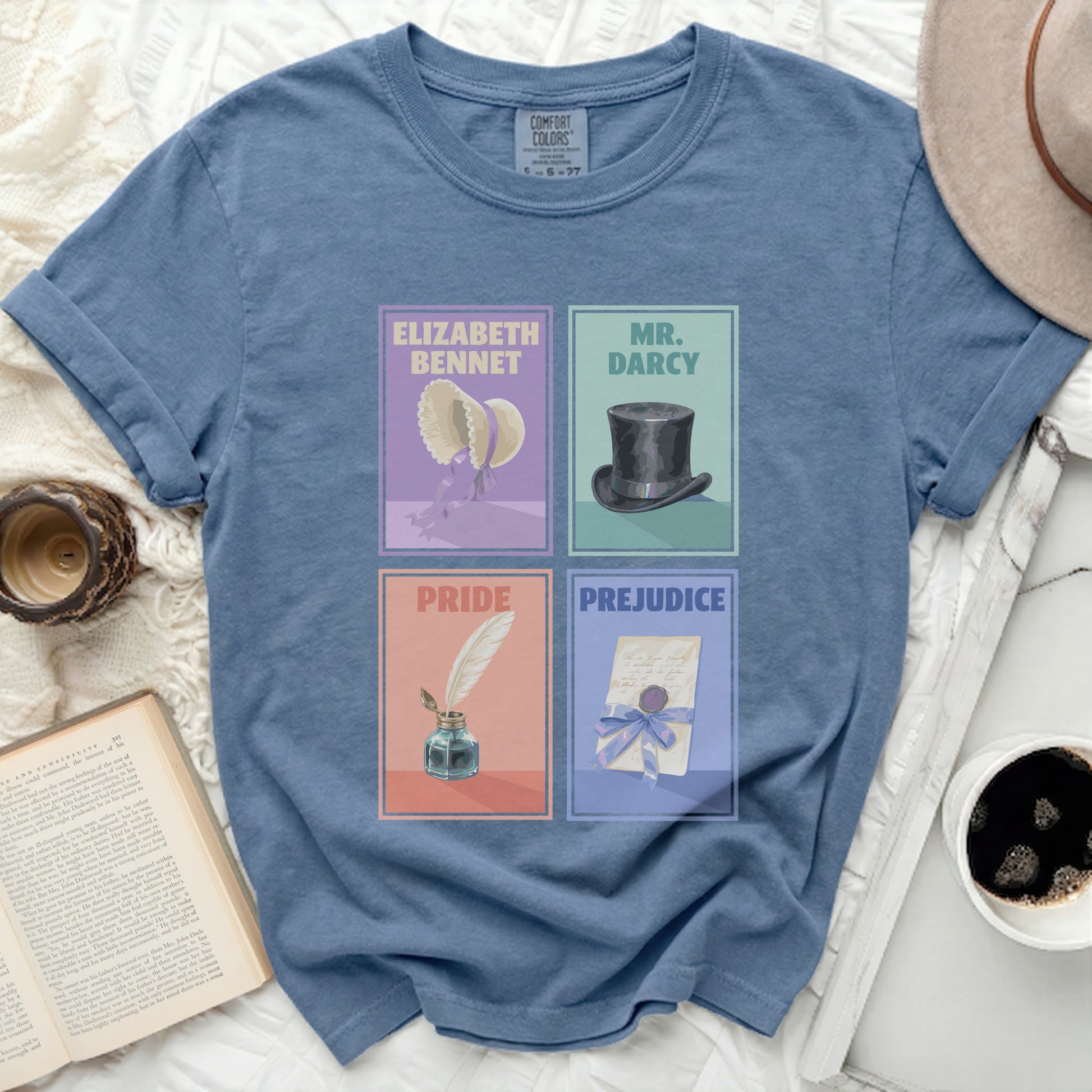 Blue t-shirt with four illustrated panels: Elizabeth Bennet, Mr. Darcy, Pride, Prejudice.