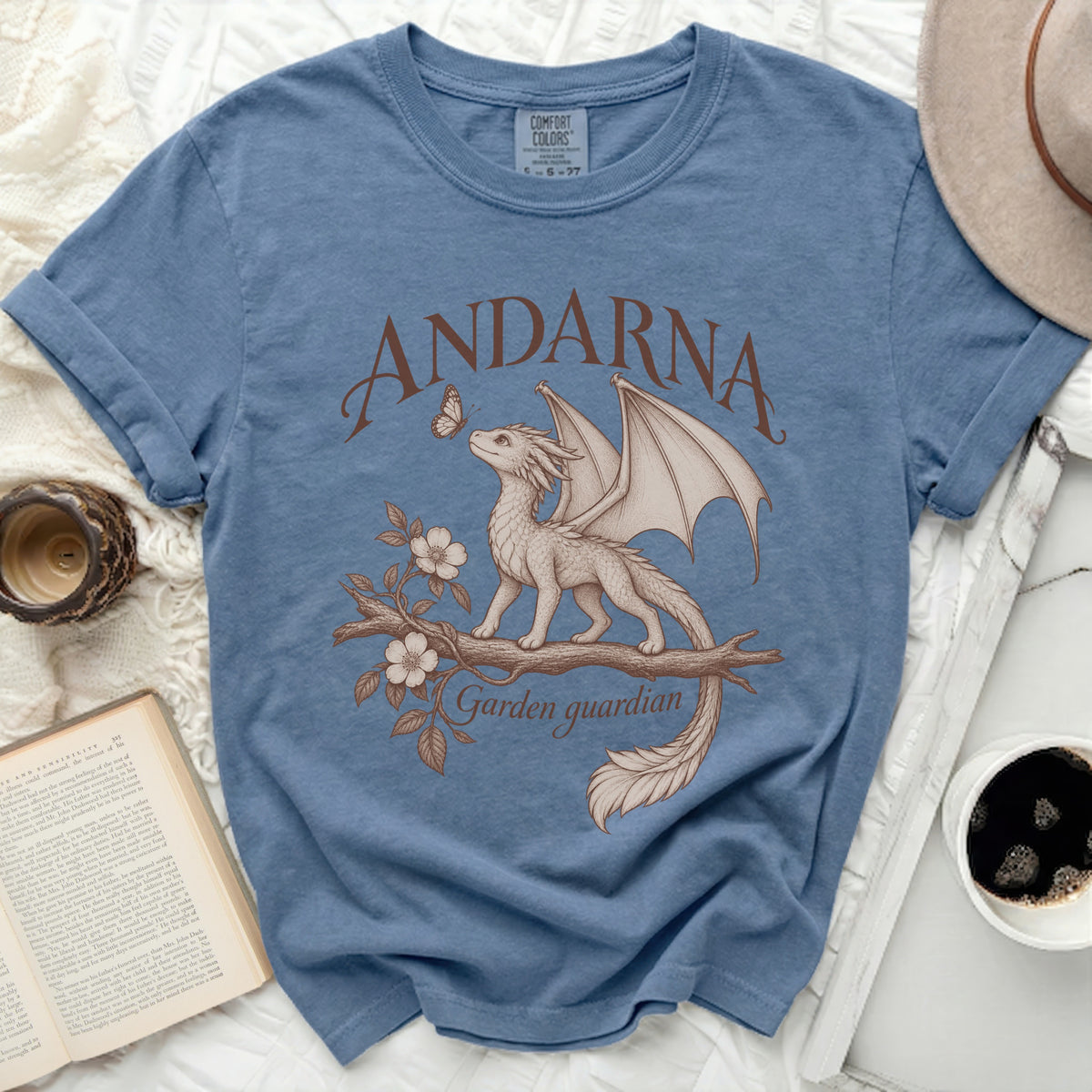 Blue t-shirt with a beige dragon on a branch, "ANDARNA" and "Garden guardian" text.