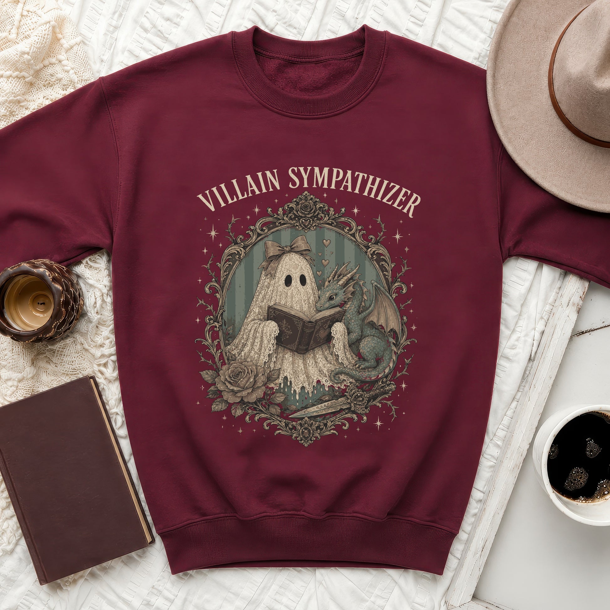 Maroon sweatshirt with "Villain Sympathizer" text and a ghost and dragon illustration.