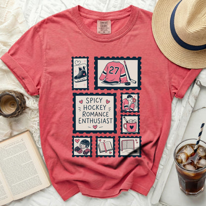 Coral t-shirt with hockey-themed stamp graphics and "Spicy Hockey Romance Enthusiast" text.