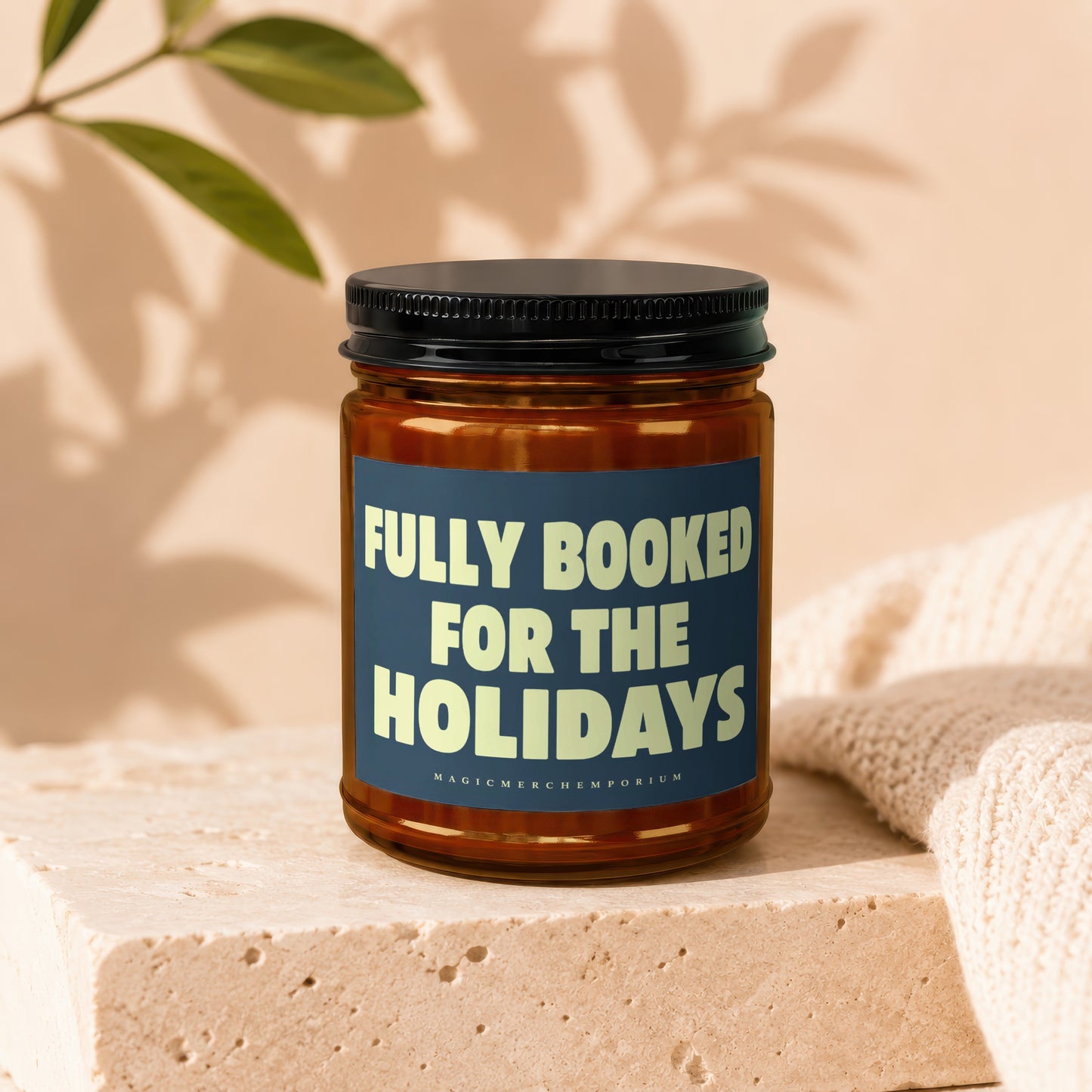 Brown candle with a dark blue label that says "FULLY BOOKED FOR THE HOLIDAYS".