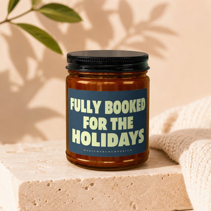 Brown candle with a dark blue label that says "FULLY BOOKED FOR THE HOLIDAYS".