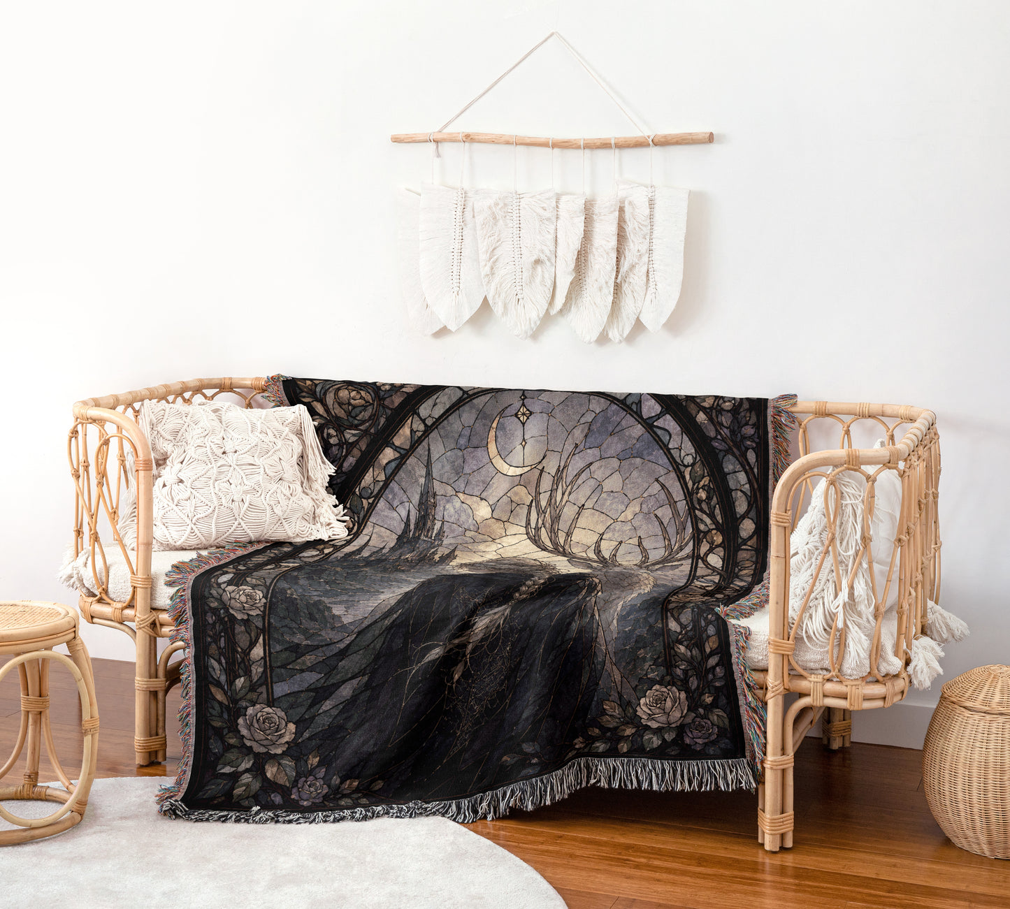 a cozy living room with a wicker bench, a black and white patterned blanket, and a hanging wall decoration made of white feathers.