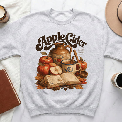 Crewneck sweatshirt with "Apple Cider a crisp autumn classic" graphic.