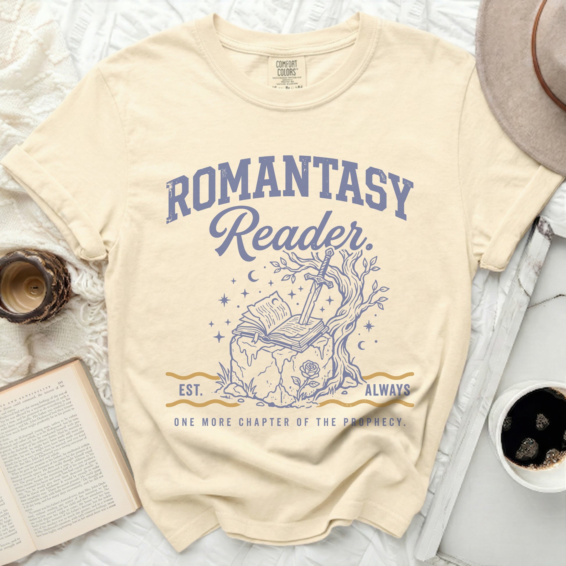 Cream t-shirt with "Romantasy Reader" text, open book, sword, and tree.