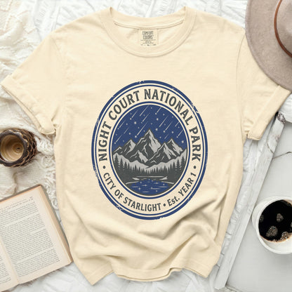 Cream t-shirt with blue circular logo for Night Court National Park, City of Starlight.