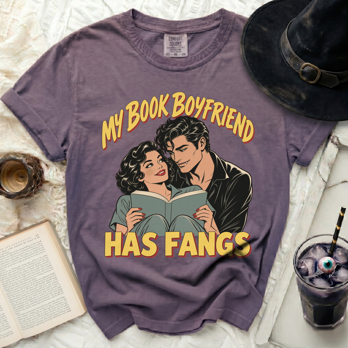 Purple t-shirt with "My Book Boyfriend Has Fangs" and comic book art.