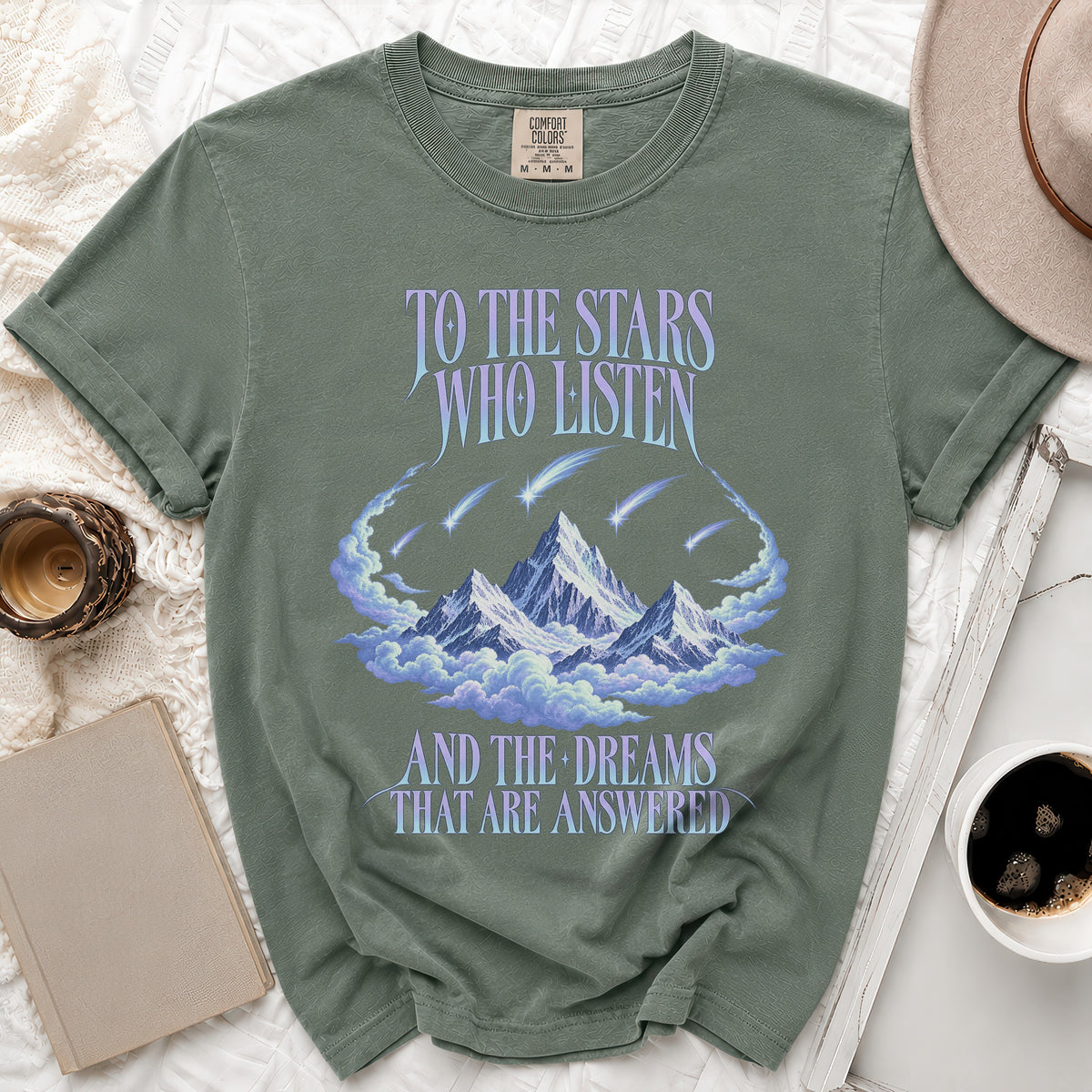 Green t-shirt with "To the Stars Who Listen and the Dreams That Are Answered" text.