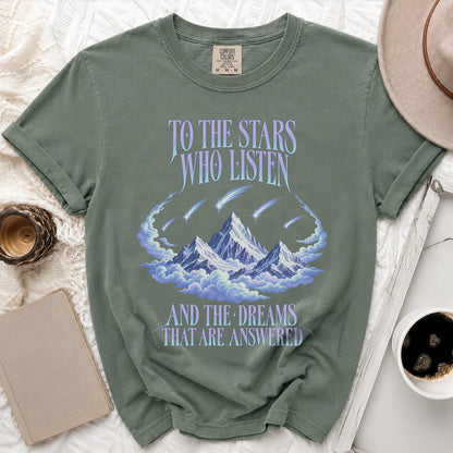 Green t-shirt with "To the Stars Who Listen and the Dreams That Are Answered" text.