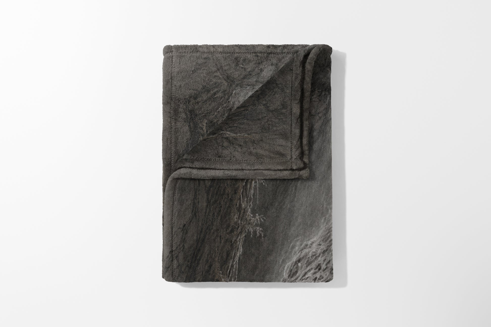 Folded grey blanket with a cracked stone pattern and a fuzzy texture.