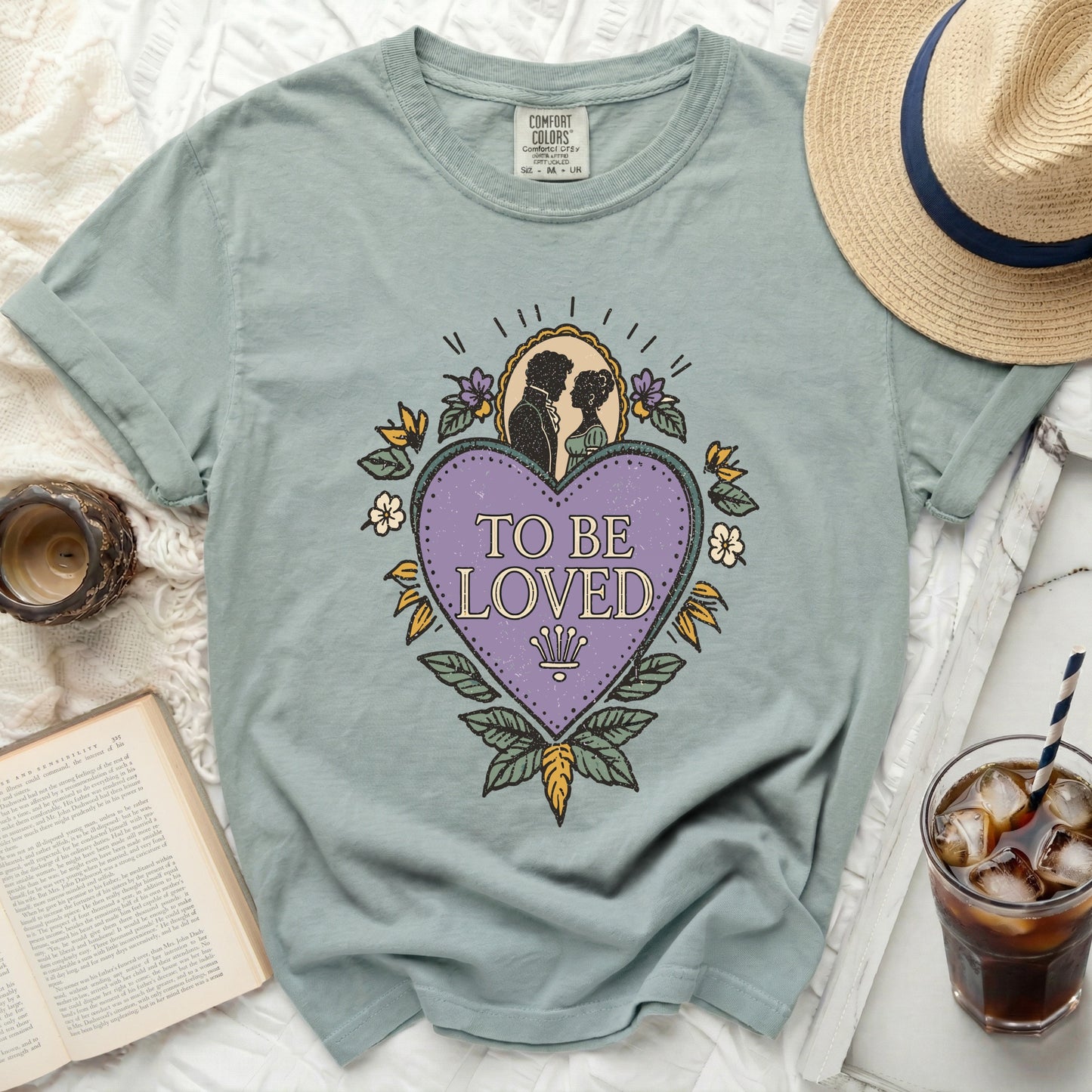 T-shirt with a purple heart graphic featuring a silhouette couple and "TO BE LOVED" text.