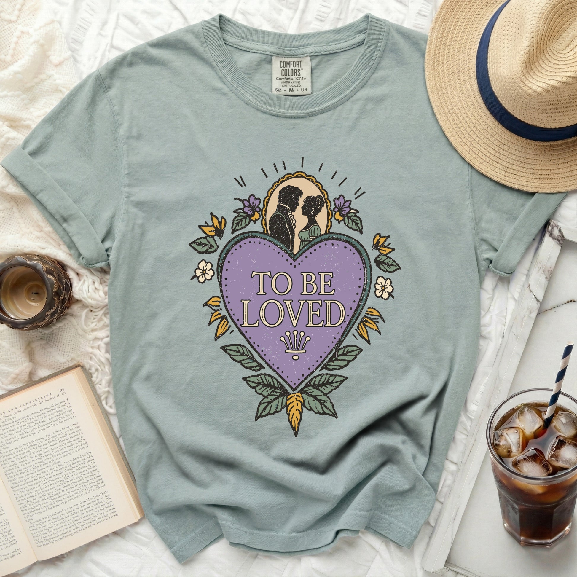 T-shirt with a purple heart graphic featuring a silhouette couple and "TO BE LOVED" text.