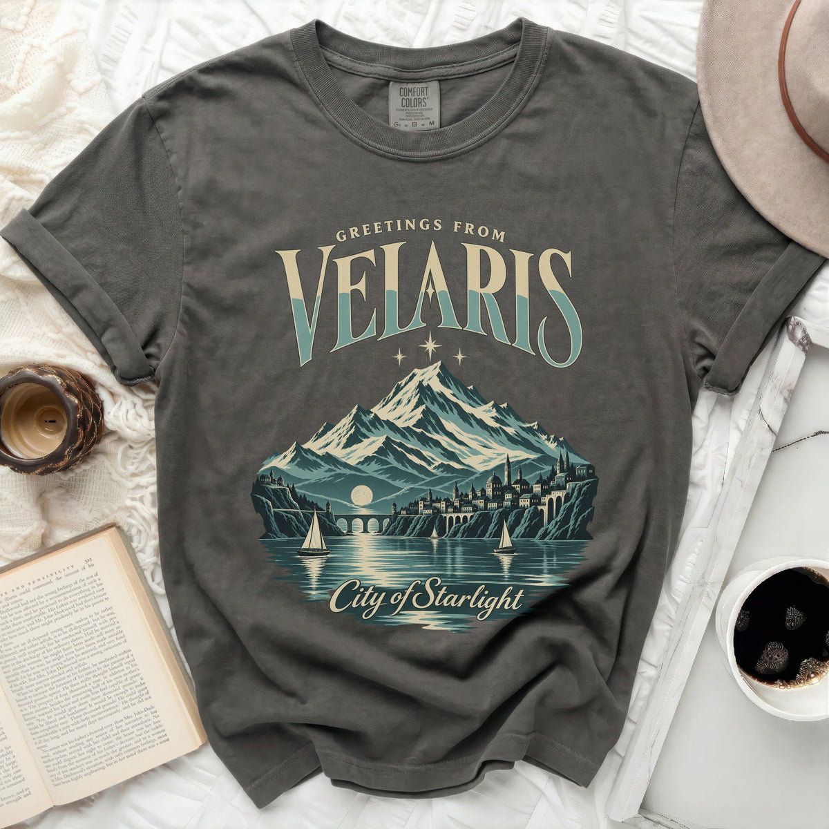Grey t-shirt with "Greetings from Velaris City of Starlight" graphic featuring mountains and city.