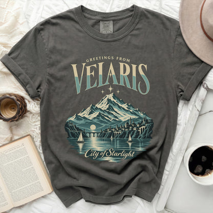 Grey t-shirt with "Greetings from Velaris City of Starlight" graphic featuring mountains and city.