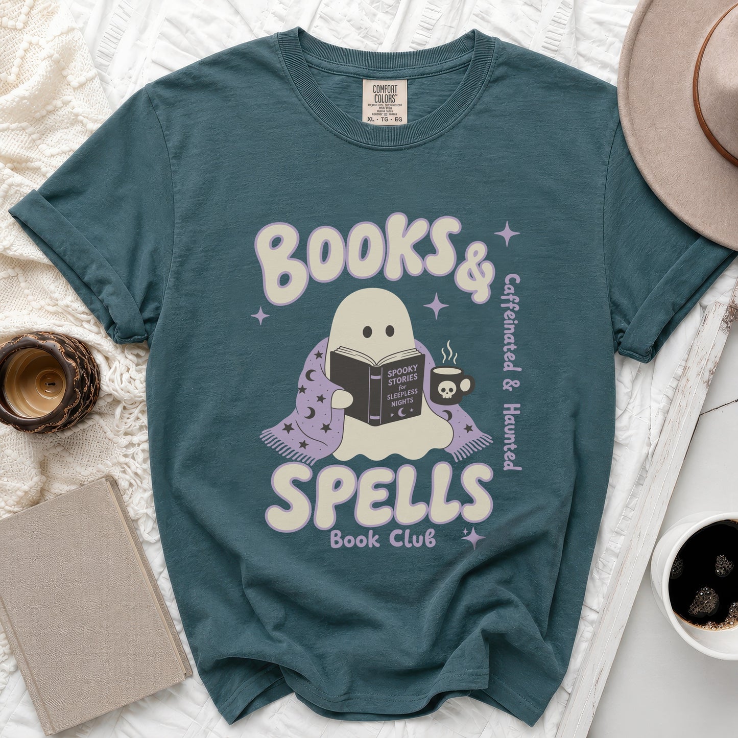 Teal t-shirt with ghost reading a book plus "Books & Spells Book Club" text.