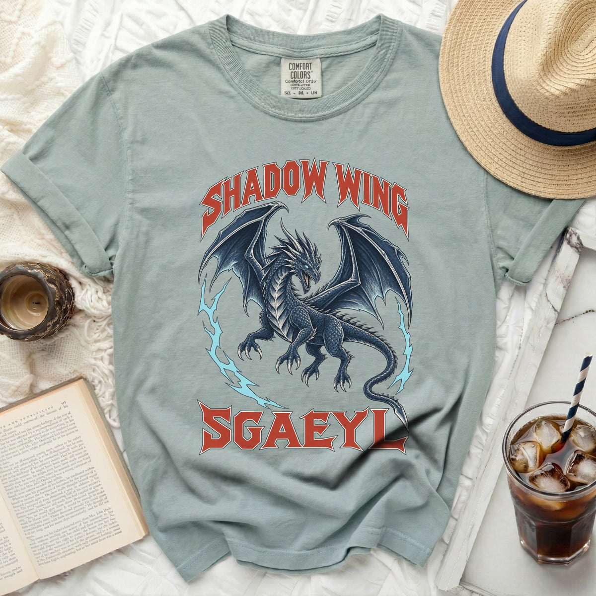 Light blue t-shirt with a dark blue dragon and "SHADOW WING SGAEYL" text.