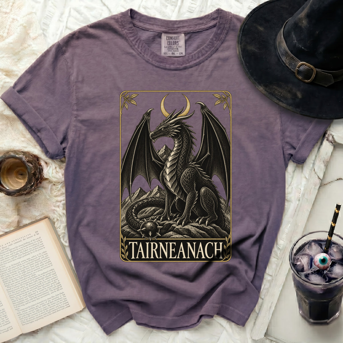 Purple t-shirt featuring a black dragon graphic with text "TAIRNEANACH".