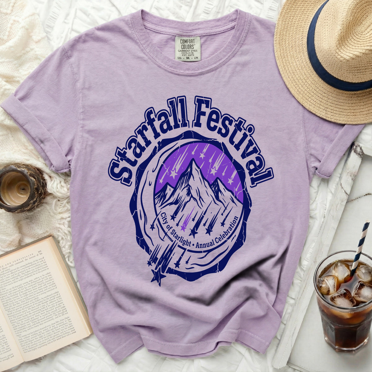 Purple t-shirt with "Starfall Festival City of Starlight Annual Celebration" graphic.