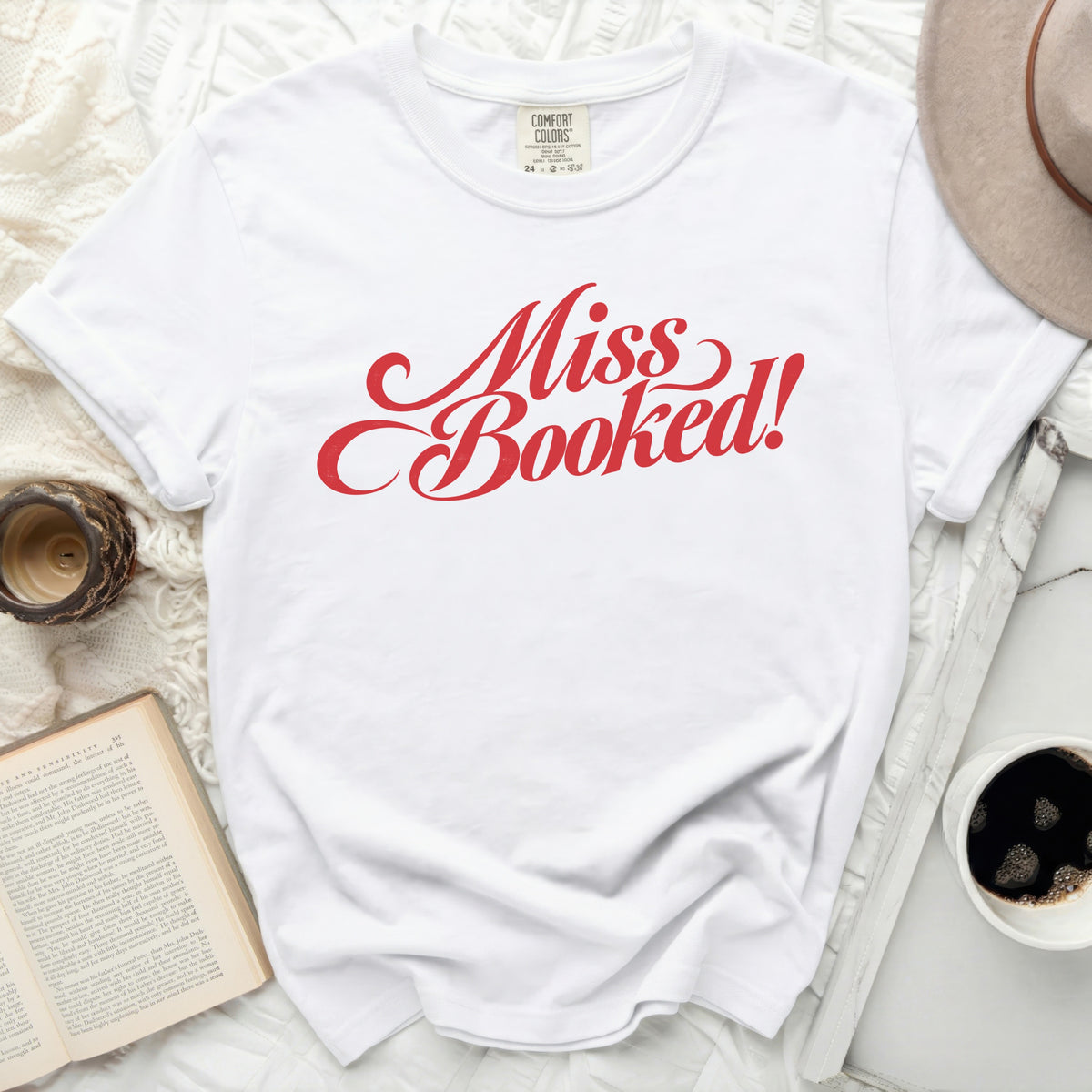 White t-shirt with red text "Miss Booked!"
