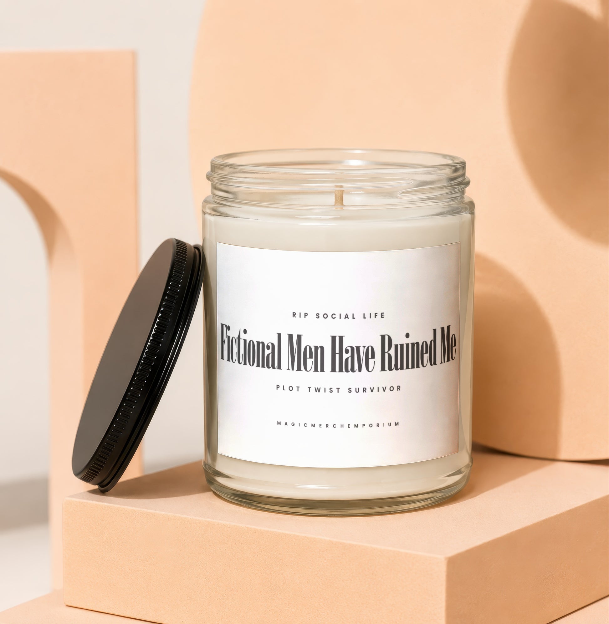 White candle in glass jar with label reading "Fictional Men Have Ruined Me".