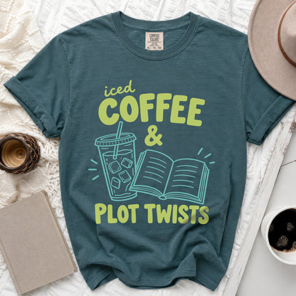 Teal t-shirt with "iced COFFEE & PLOT TWISTS" graphic and iced coffee cup and book illustration.
