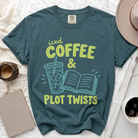 Teal t-shirt with "iced COFFEE & PLOT TWISTS" graphic and iced coffee cup and book illustration.