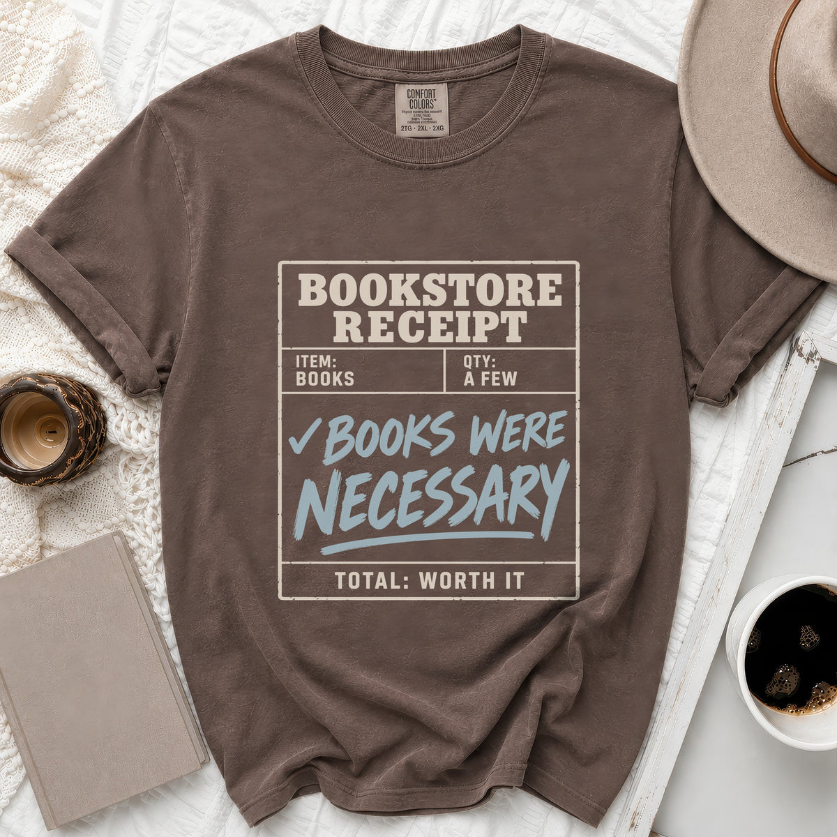 Brown t-shirt with a bookstore receipt graphic reading "Books Were Necessary".